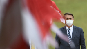 Jair Bolsonaro caminha em meio a bandeiras no evento de abertura do ano legislativo