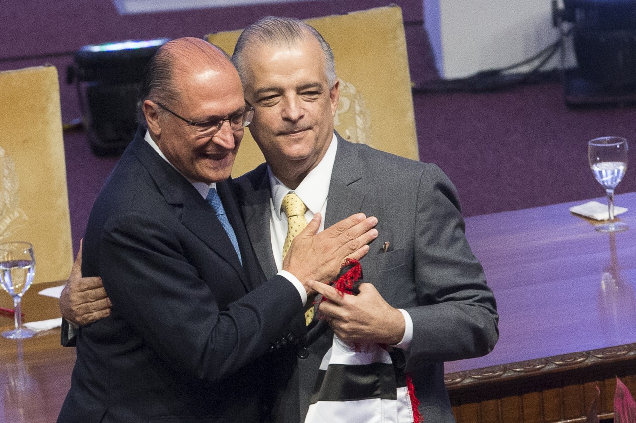 Geraldo Alckmin abraçando e batendo no peito de Márcio França