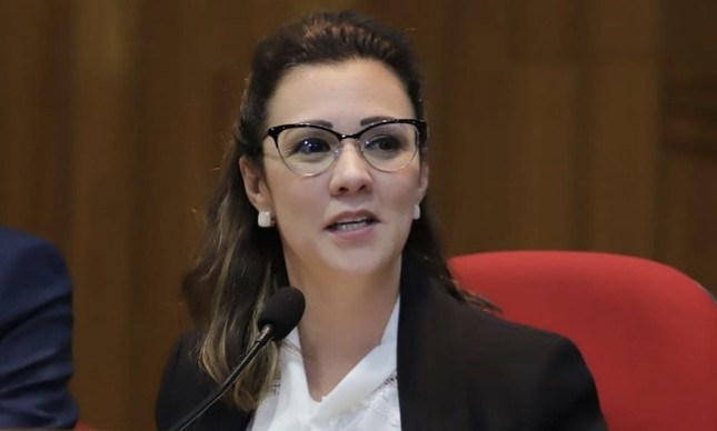 Mulher de óculos discursa