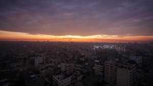 Al Shifa hospital is lit up during sunrise in Gaza City