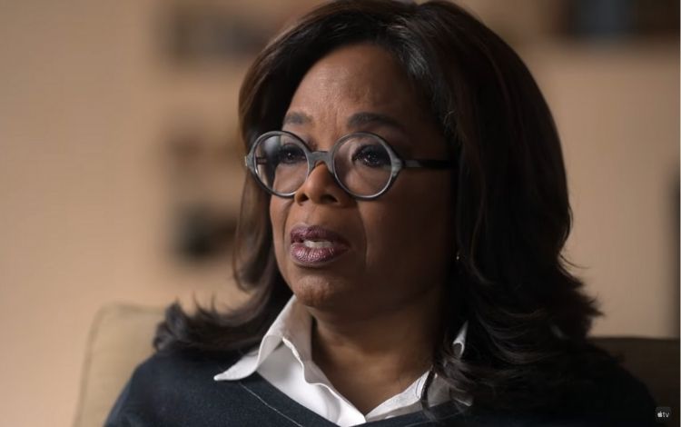 Oprah Winfrey falando com uma feição triste