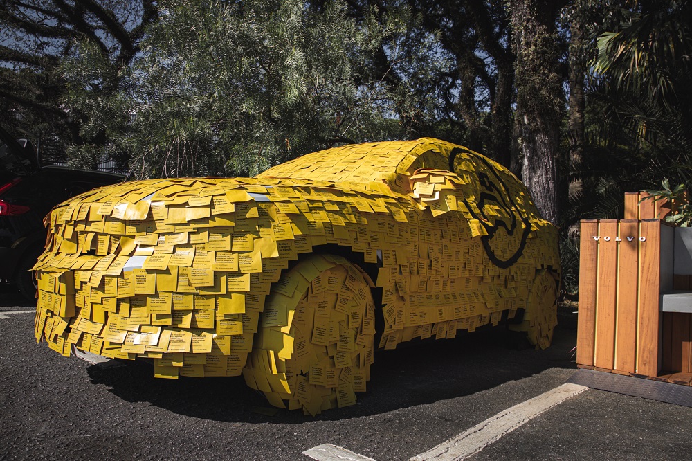 Carro da Volvo estacionado em vaga no Parque do Ibirapuera e todo coberto por post-its amarelos com mensagens que ressaltam a segurança (mas não estão legíveis na fotografia)