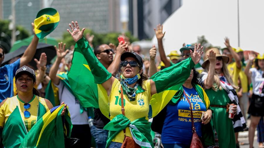 Grupo de manifestantes com camisetas e bandeiras do Brasil