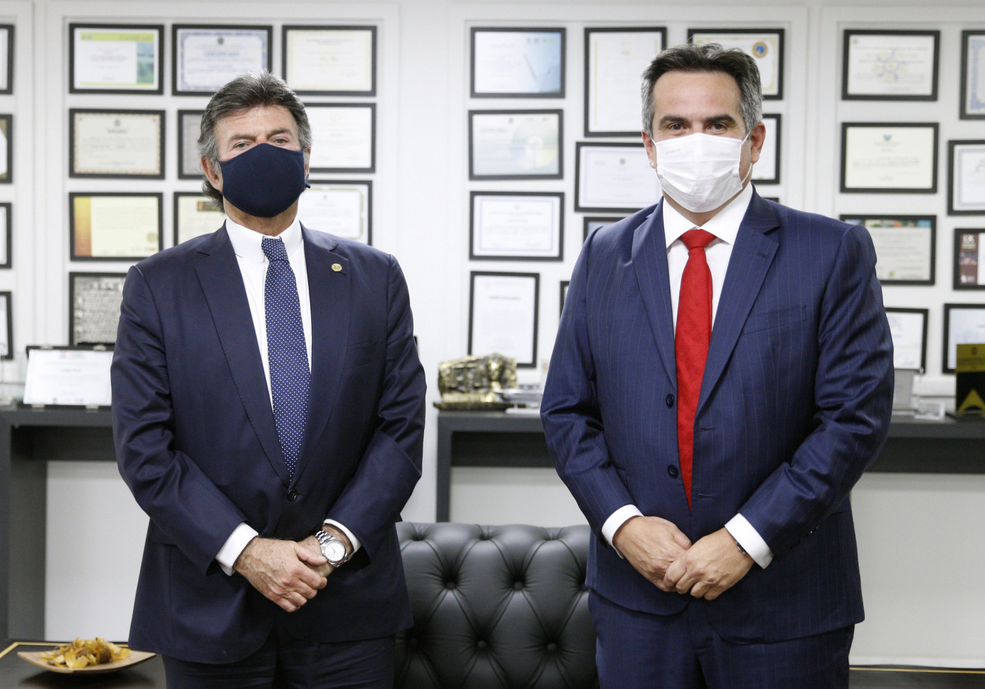 Luiz Fux e Ciro Nogueira, dois homens de terno azul marinho e usando máscaras de proteção lado a lado com distanciamento, posando para a foto.