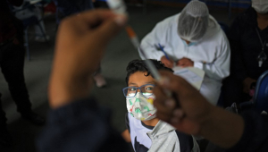 menino olhando vacina na Bolívia