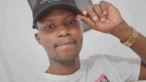 Moïse Kabagambe: homem negro jovem com a mão em alça de boné