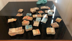 Maços de dinheiro apreendidos em operação do Ministério Público sobre uma mesa