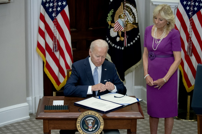 US First Lady Jill Biden watches US President Joe Biden sign the Safer Communities Act