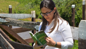 Rafaela Aiex Parra segura seu livro "Fundação Social da Propriedade Rural