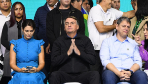 Michelle Boslonaro, de azul, Jair Bolsonaro, de preto, e Tarcísio de Freitas, de azul claro e calça jeans, todos sentados