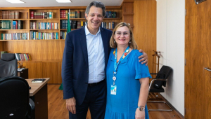 Maria Rita Serrano, presidente da Caixa, ao lado de Fernando Haddad