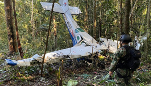 Foto divulgada pelo Exército da Colômbia mostrando um soldado ao lado dos destroços de uma aeronave que caiu na floresta amazônica