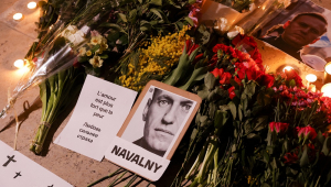 cartazes com retratos, flores e velas exibidos como parte de um comício em homenagem a Alexei Navalny