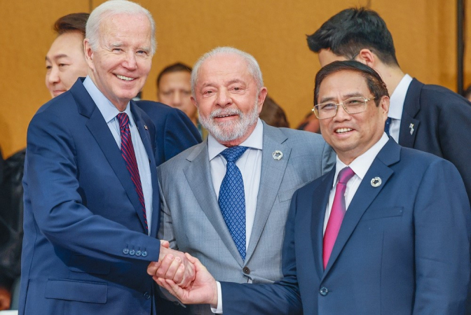 Lula entre JOe Biden e o primeiro ministro do Vietnâ, Pham Minh Chinh, todos dando as mãos