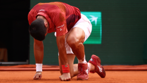 O sérvio Novak Djokovic reage depois de cair na quadra durante a partida individual masculina das oitavas de final contra o argentino Francisco Cerundolo na quadra Philippe-Chatrier no nono dia do torneio de tênis do Aberto da França no Complexo Roland Garros em Paris, em 3 de junho de 2024.