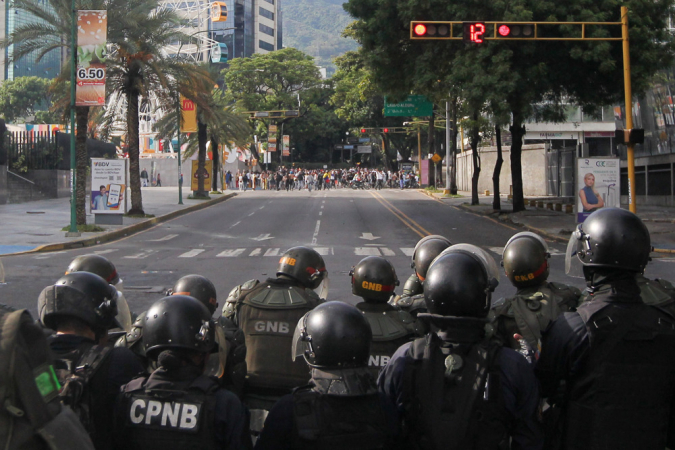 Membros da Polícia Nacional patrulham a autoestrada Francisco Fajardo durante um protesto contra os resultados das eleições presidenciais