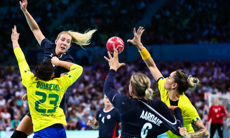 A lateral esquerda norueguesa nº 14 Kristine Breistol salta sobre a lateral direita nº 23 do Brasil Giulia Guarieiro (E) durante a partida de handebol feminino entre Noruega e Brasil das quartas de final dos Jogos Olímpicos de Paris 2024, no estádio Pierre-Mauroy, em Villeneuve-d'Ascq , norte da França, em 6 de agosto de 2024