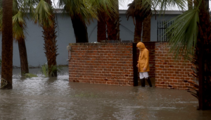 Uma pessoa caminha por uma rua inundada causada pela chuva e tempestade do furacão Debby em 5 de agosto de 2024, em Cedar Key, Flórida.