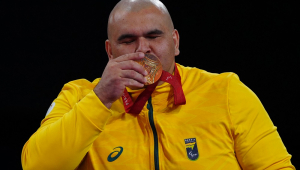 Gold medallist Brazil's Wilians Silva de Araujo poses on the podium during the victory ceremony for the Men's +90kg J1 final event at the Champ-de-Mars arena in Paris on September 7, 2024. (Photo by Dimitar DILKOFF / AFP)