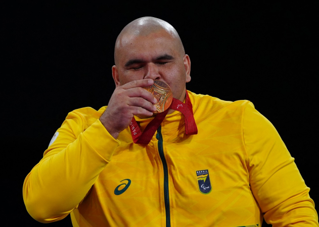 Gold medallist Brazil's Wilians Silva de Araujo poses on the podium during the victory ceremony for the Men's +90kg J1 final event at the Champ-de-Mars arena in Paris on September 7, 2024. (Photo by Dimitar DILKOFF / AFP)