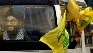 (FILES) A poster of Hezbollah leader Hassan Nasrallah and flags of the group decorate a bus heading to the southern suburb of Beirut on February, 22 2006 to attend a massive "victory" rally. Lebanon's Iran-backed Hezbollah group confirmed on September 28, 2024 that its leader Hassan Nasrallah had been killed, after Israel said it had "eliminated" him in a strike on south Beirut a day earlier