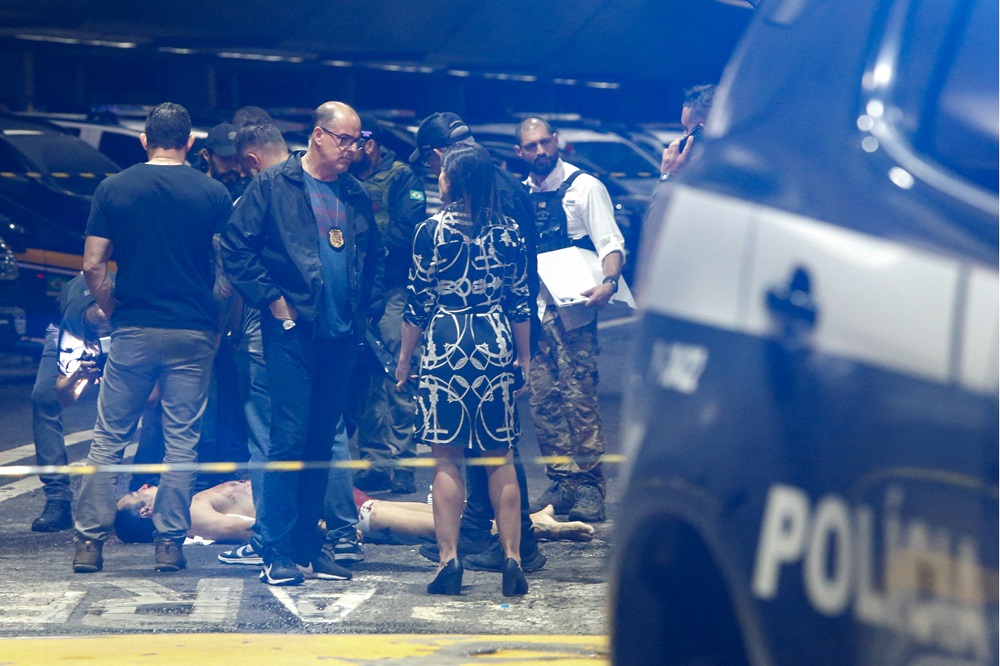 Policiais e peritos forenses atendem à cena de um tiroteio no aeroporto internacional de Guarulhos