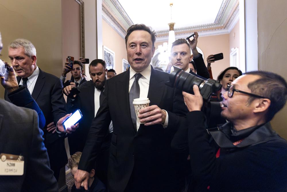 O empresário norte-americano Elon Musk (C), escolhido pelo presidente eleito Donald Trump para liderar o recém-criado Departamento de Eficiência Governamental (DOGE), deixa uma reunião com o próximo líder da maioria no Senado, John Thune, no Capitólio dos Estados Unidos, em Washington