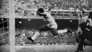 Pelé aproveita o rebote do goleiro paraguaio e marca o único gol da partida entre Brasil e Paraguai, no estádio do Maracanã, pelas Eliminatórias para a Copa do Mundo no México