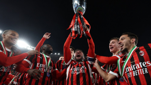 O defensor italiano do Milan, Davide Calabria (#2), carrega o troféu enquanto ele e seus companheiros de equipe comemoram com os torcedores após vencerem a final da Supercopa da Itália contra a Inter de Milão,