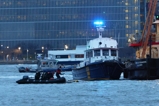Equipes trabalham para remover um helicóptero acidentado do Rio Hudson