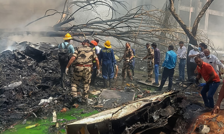 This handout taken and posted on the X (formerly Twitter) account of the Central Industrial Security Force (CISF) On June 12, 2025 shows rescue officials working at the site where Air India flight 171 crashed in a residential area near the airport in Ahmedabad. The London-bound Air India flight 171 passenger plane crashed on June 12 in India's western city of Ahmedabad with 242 on board, aviation officials said in what the airline called a "tragic accident". (Photo by Handout / CENTRAL INDUSTRIAL SECURITY FORCE (CISF) / AFP) / -----EDITORS NOTE --- RESTRICTED TO EDITORIAL USE - MANDATORY CREDIT "AFP PHOTO / CENTRAL INDUSTRIAL SECURITY FORCE (CISF) " - NO MARKETING - NO ADVERTISING CAMPAIGNS - DISTRIBUTED AS A SERVICE TO CLIENTS