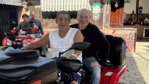 Ney Matogrosso passeia na garupa de Zeca Pagodinho em quadriciclo pelas ruas de Xerém