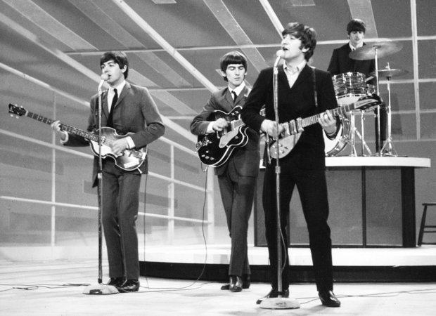 Paul McCartney, George Harrison, John Lennon, e Ringo Starr, se apresentam em programa televisivo na Inglaterra.