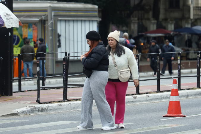 Pedestres se protegem do frio na Avenida Paulista, na região centro-sul de São Paulo