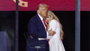 O presidente norte-americano Donald Trump (esq.) abraça Erika Kirk (dir.), viúva de Charlie Kirk, durante homenagem ao ativista no estádio State Farm, no Arizona