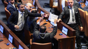 Parlamentar israelense Ayman Odeh segura uma placa com os dizeres 'Reconhecer a Palestina' durante discurso de Trump no Parlamento israelense