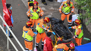 Conteúdo gráfico / Um corpo é transferido para ser identificado após um grande incêndio que devastou vários blocos de apartamentos no conjunto residencial Wang Fuk Court, no distrito de Tai Po, em Hong Kong, em 28 de novembro de 2025. Famílias das dezenas de pessoas ainda desaparecidas após o pior incêndio em Hong Kong em décadas vasculharam hospitais em 28 de novembro, quando as operações de combate aos bombeiros terminaram, com o número de mortos em pelo menos 94.