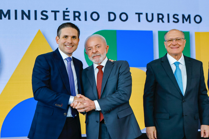 Lula e Hugo Motta se cumprimentam durante cerimônia de transmissão de cargo e posse do Ministro do Turismo