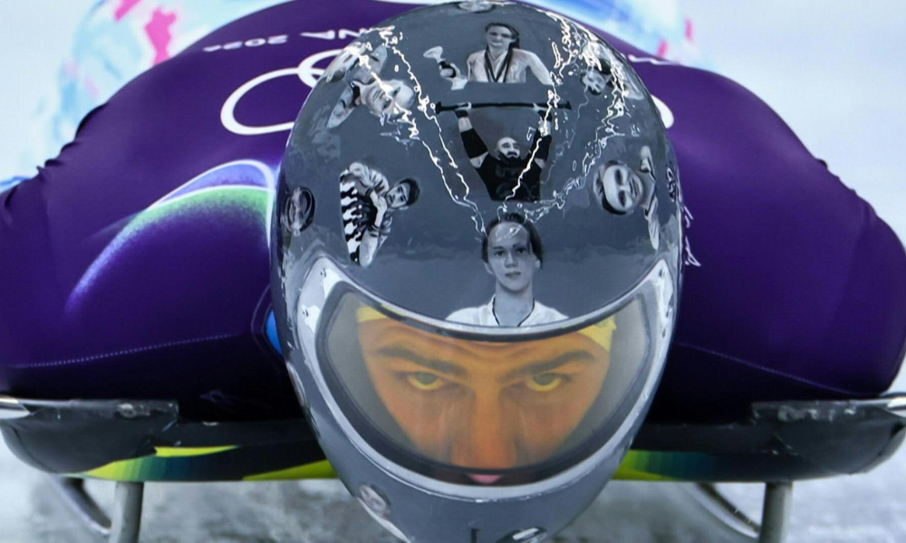 Atleta ucraniano Vladislav Heraskevych com capacete com imagens de atletas mortos durante o conflito com a Rússia