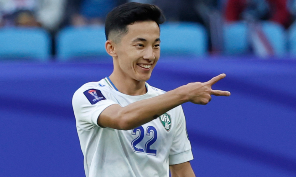 Uzbekistan's midfielder #22 Abbosbek Fayzullaev celebrates after scoring his team's second goal during the Qatar 2023 AFC Asian Cup football match between Uzbekistan and Thailand at Al-Janoub Stadium in al-Wakrah, south of Doha, on January 30, 2024. (Photo by KARIM JAAFAR / AFP)